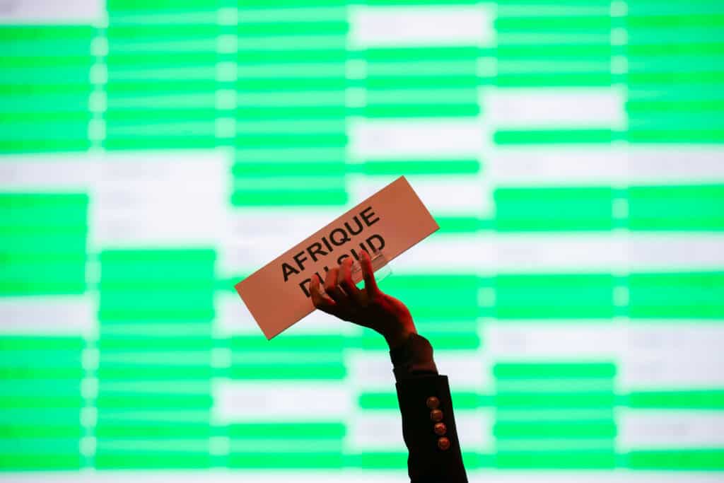 A representative at a humanitarian organization raising their placard in the air.